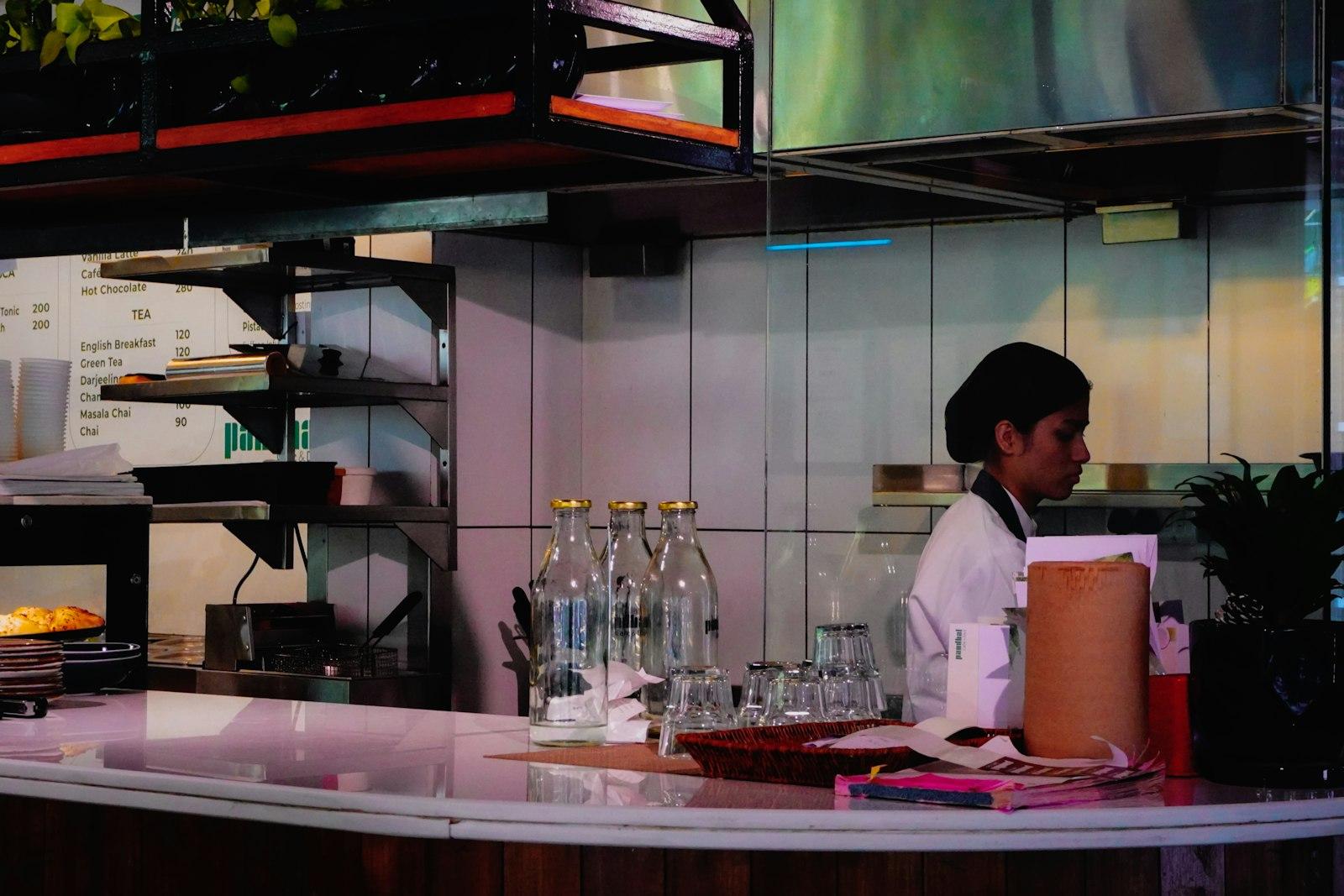 Staf kafe sedang bekerja di balik counter yang sibuk